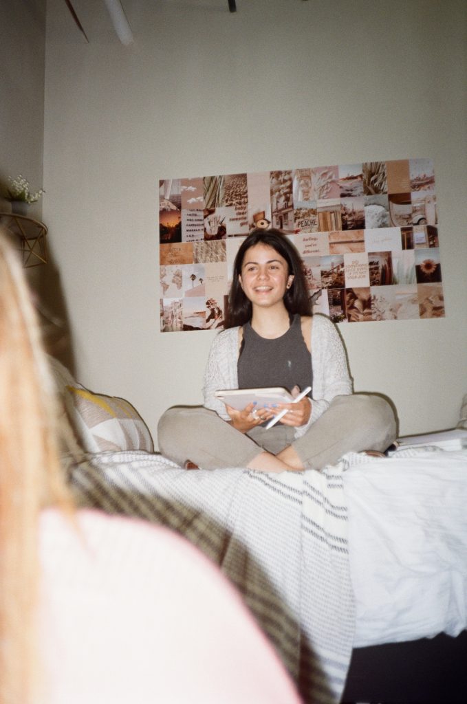 Student smiling in dorm room