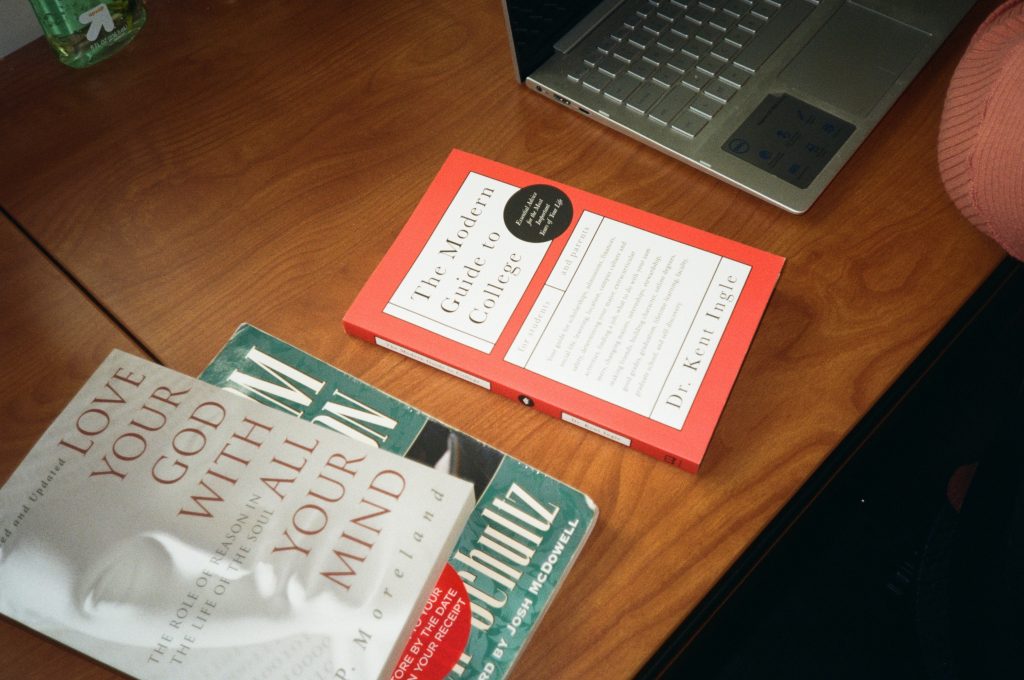 The modern guide to college book on desk next to computer