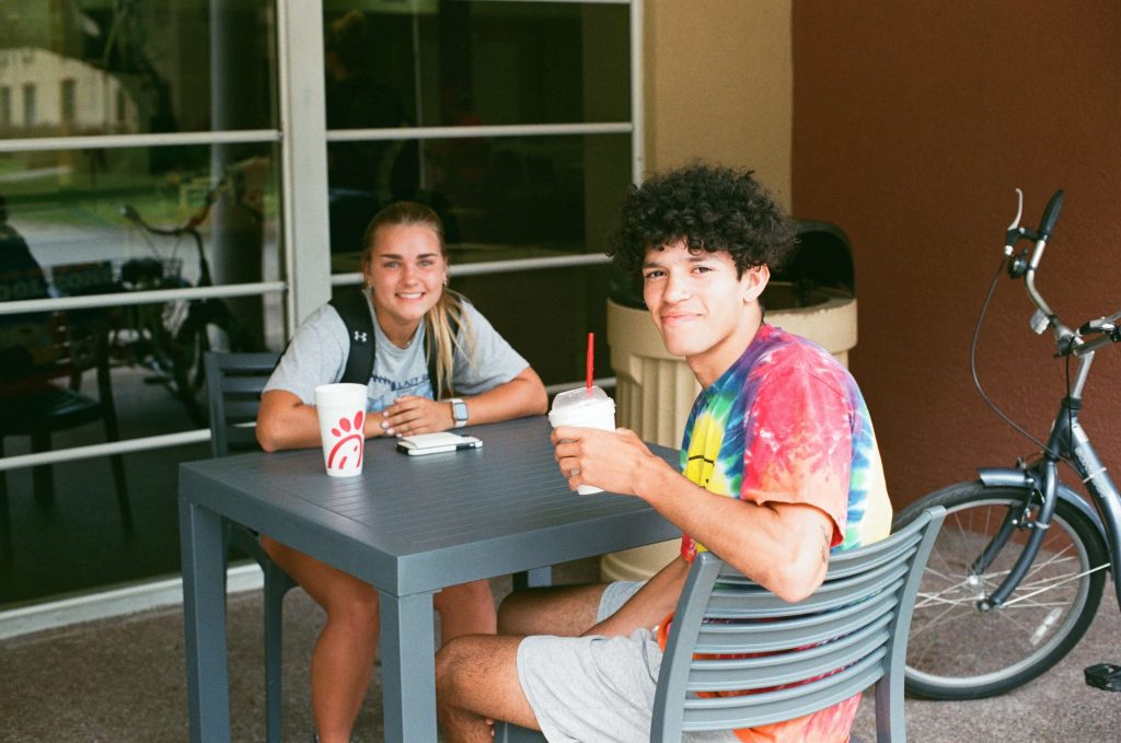 Two students smiling outside of mi casa resturaunt