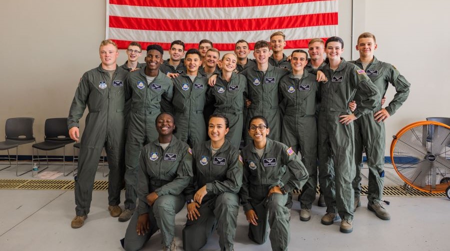 Students smiling in aviation suits