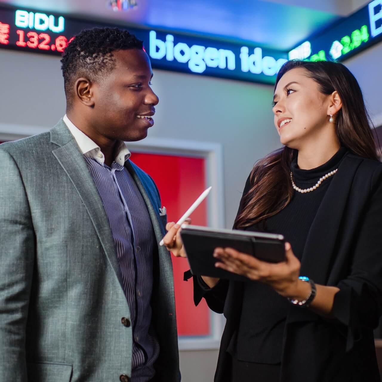 Two business students in front of the business lab