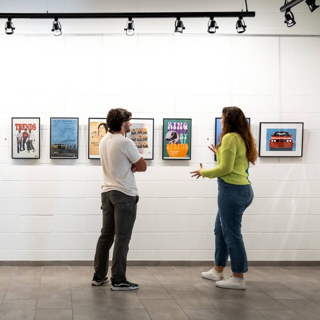 Two students viewing art in an art gallery
