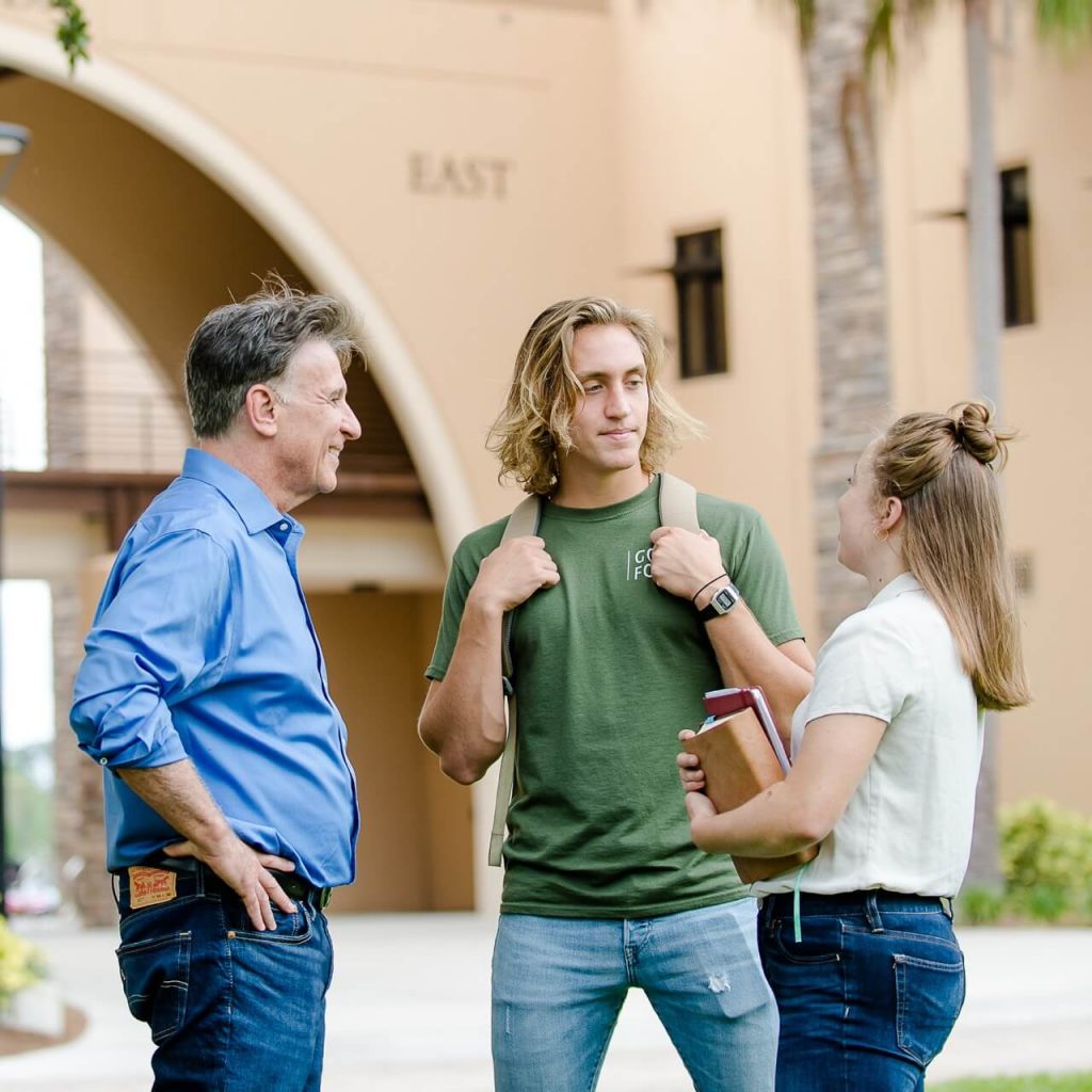 Ministry students talking with professor on campus