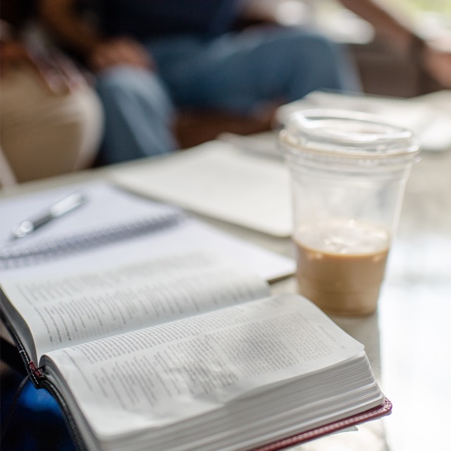 Bible and cup of coffee sitting on a table