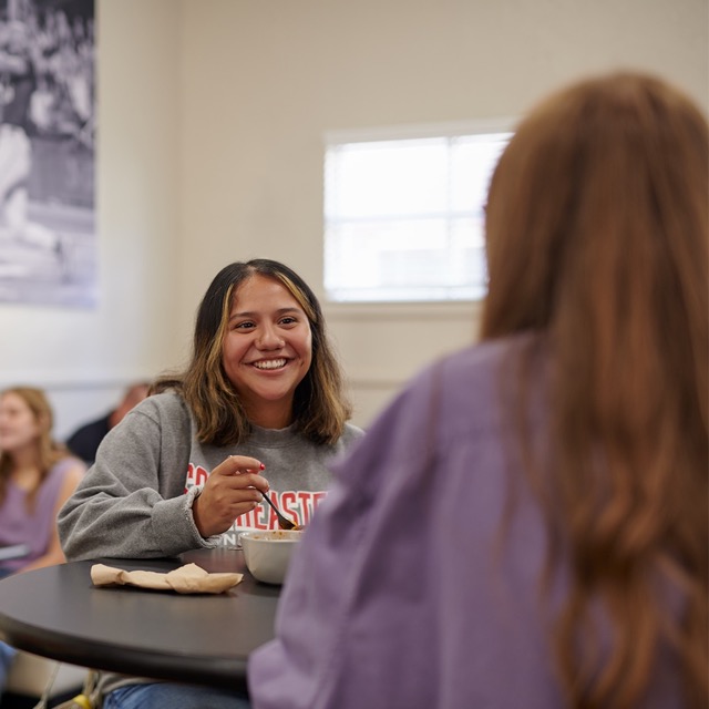 Female student eating a meal with a friend in our on-campus dining facilities.