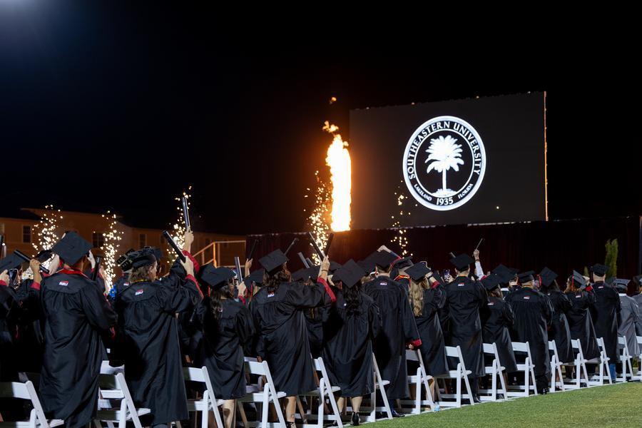 Picture of graduates standing Fall '25 Commencement