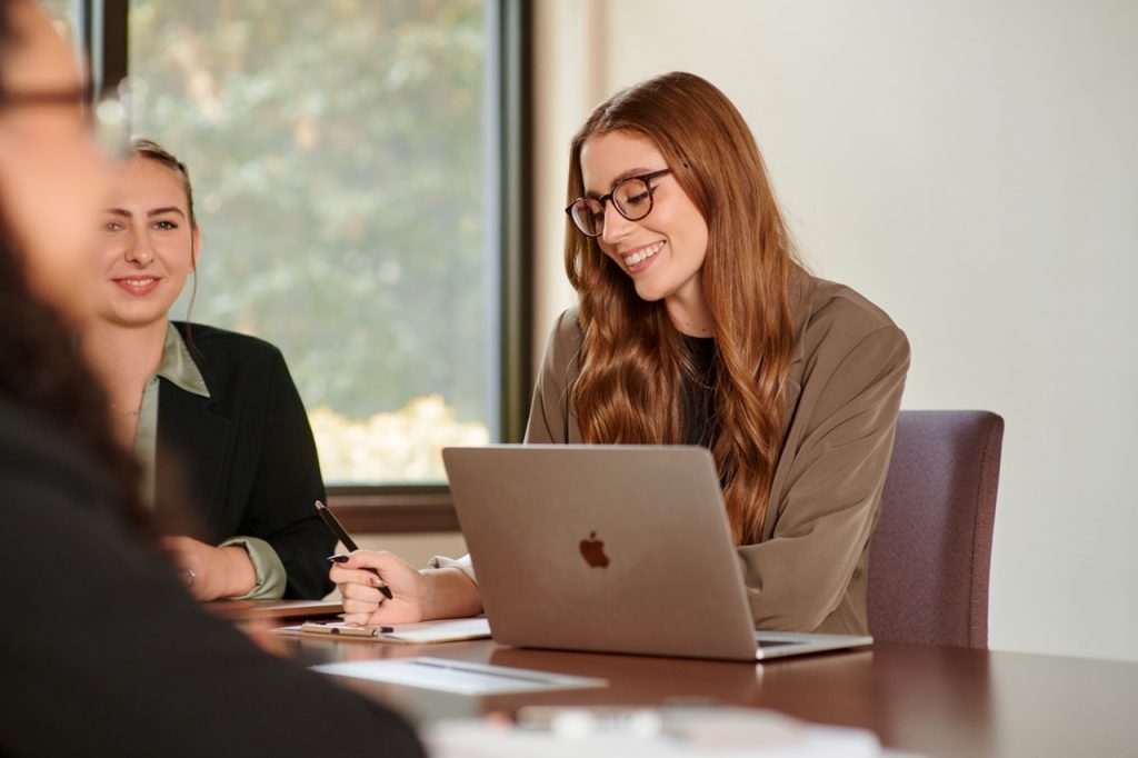 Female professional sitting at a table with laptop