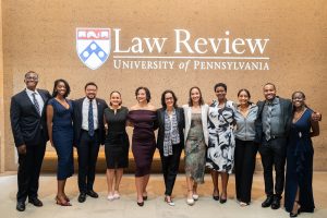 Group of people standing in front of the University of Pennsylvania Law Review sign.