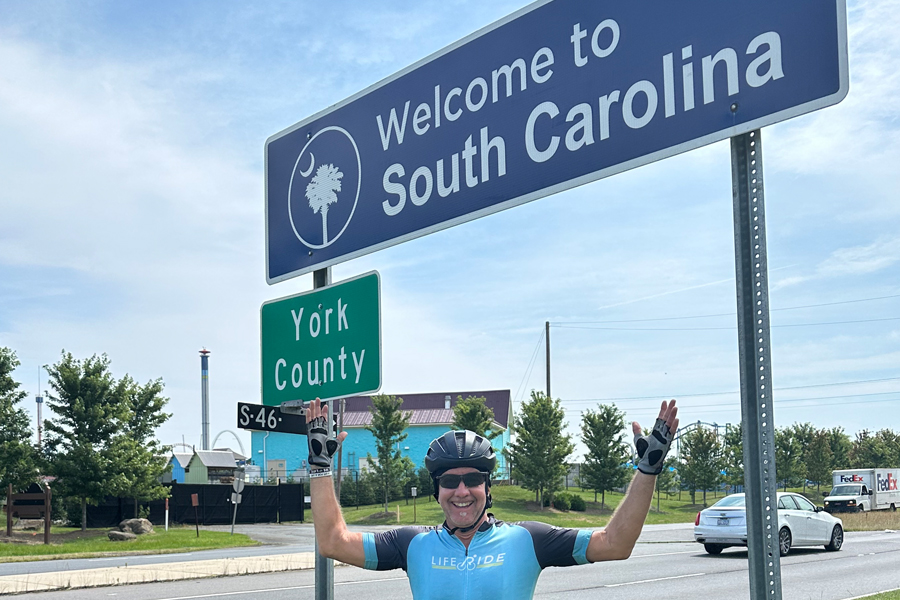 Jay Stewart standing in front of South Carolina Welcome sign.