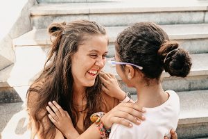 Lovina Botone laughing with child