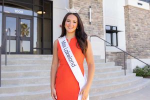 SEU student, Maci Miotto, wearing Miss Lakeland 2025 sash in front of Welcome Center