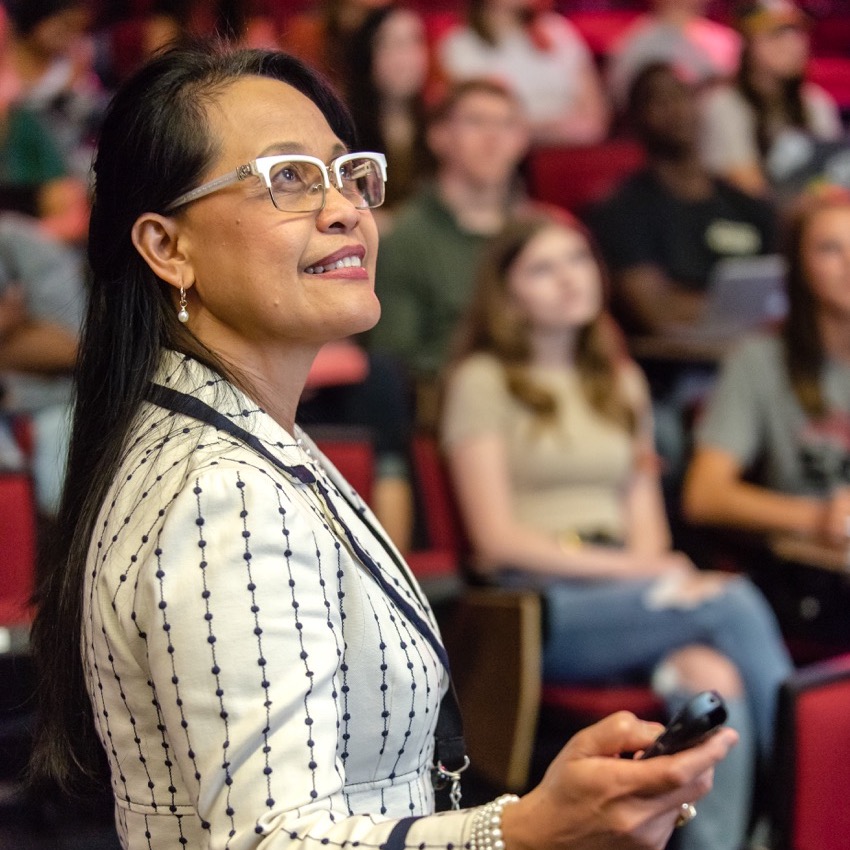 female professor teaching a class in an auditorium