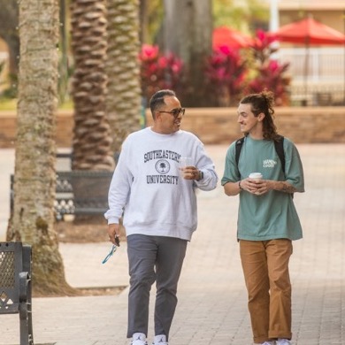 Professor walking around campus with a student