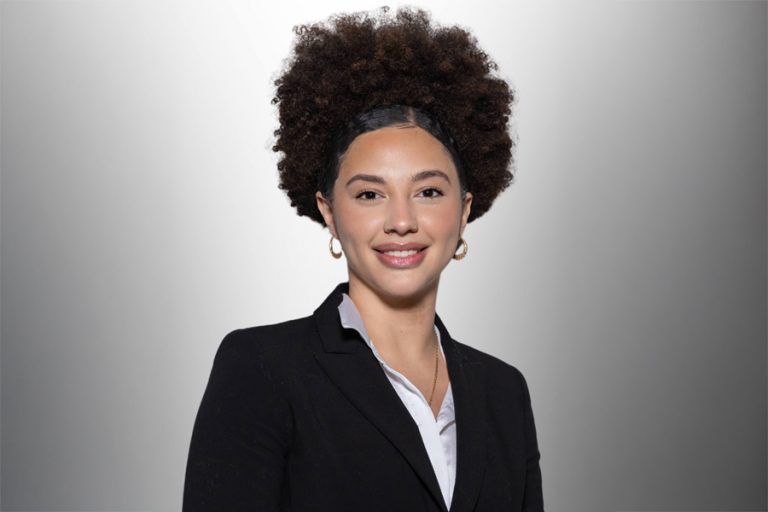 Photo of SEU Alumna Nathalie Rincon. She is wearing a business suit and smiling.
