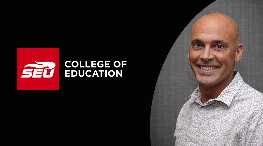 Man smiling while next to College of Education Logo