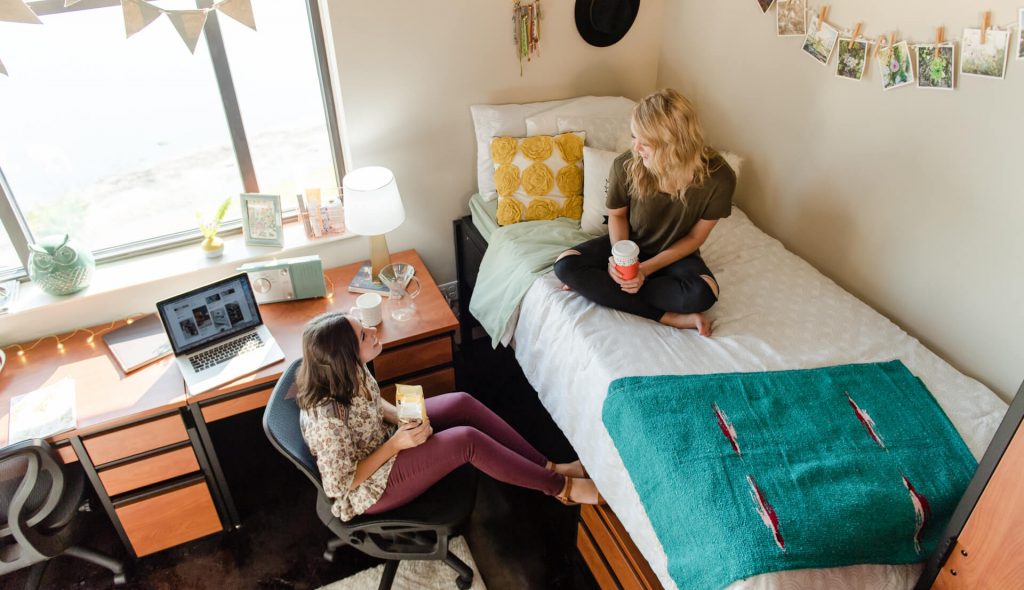 Two girls sitting in dorm room