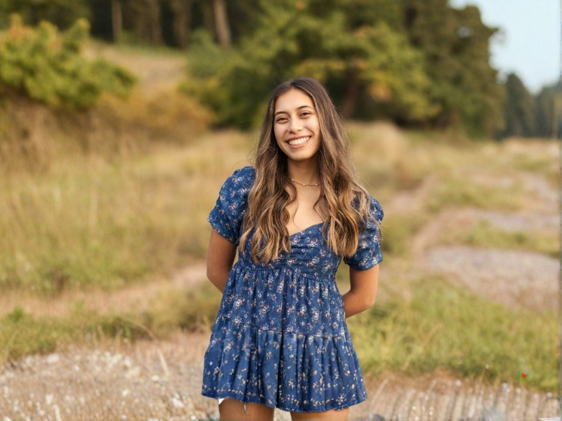 Aryana Almanza standing in a field smiling.