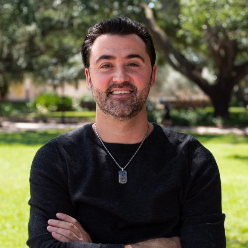 Headshot of a man outside.