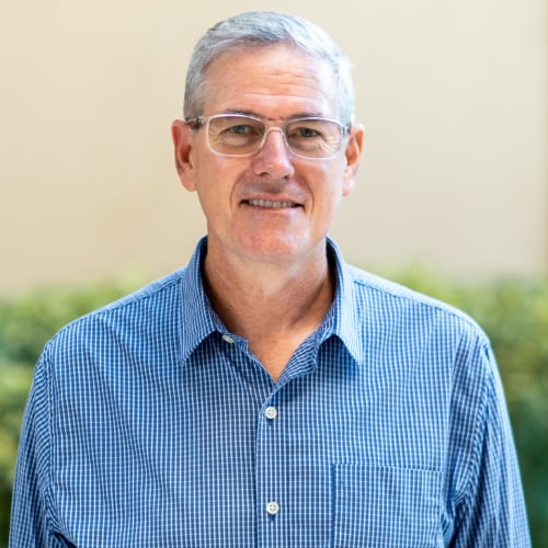 Headshot of a man outside.