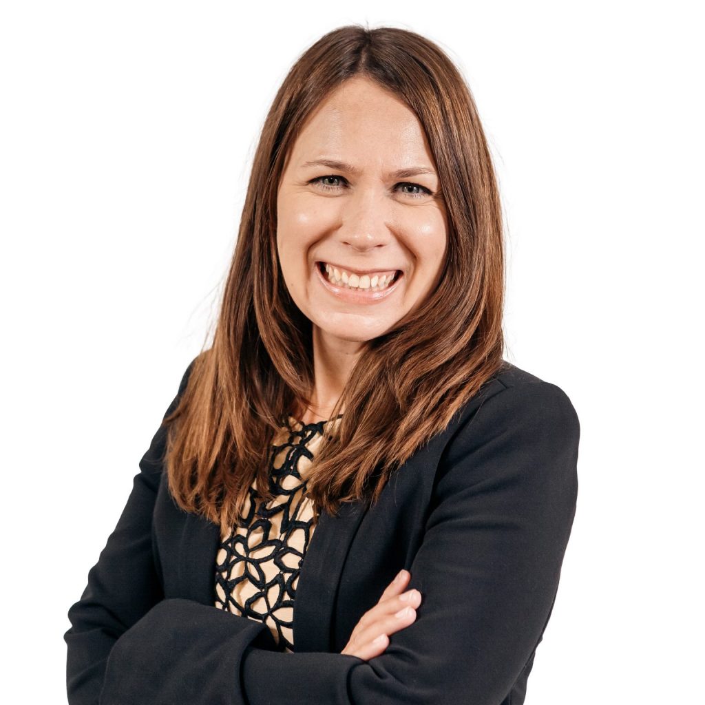 Headshot of woman in front of a white background.