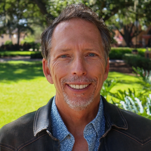 Headshot of a man outside.
