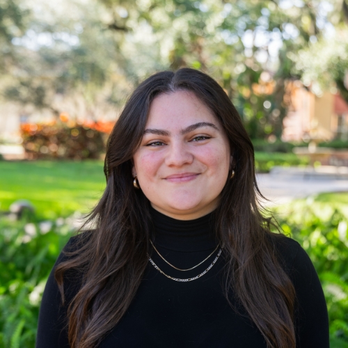 Headshot of a woman outside.