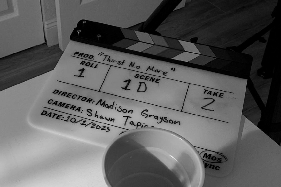 Clapperboard sitting on table(black and white).